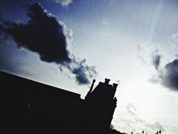 Low angle view of building against cloudy sky