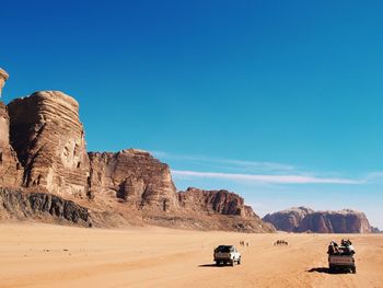 Scenic view of desert against clear blue sky