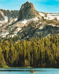 Scenic view of lake by mountains against sky