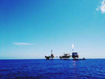 Scenic view of sea against blue sky