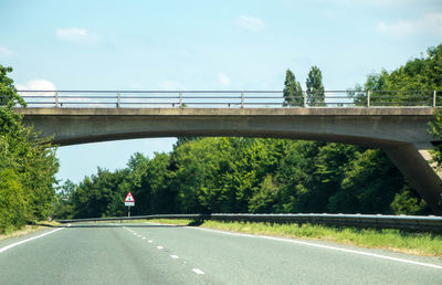 Bridge over road against sky
