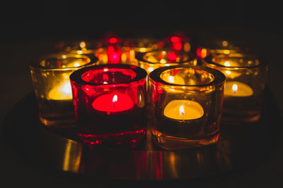 Close-up of illuminated tea light candles on table