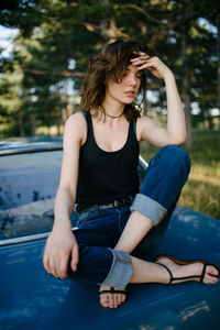 Young woman sitting in car