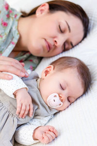 Baby girl sleeping on bed