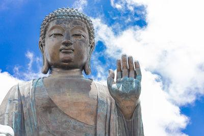 Low angle view of statue against sky