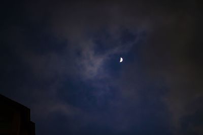 Low angle view of silhouette moon against sky at night