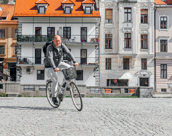 Portrait of a handsome hipster man. a man in a big city cycling down the street on a bicycle