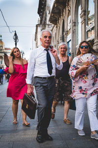 Group of people walking in front of building