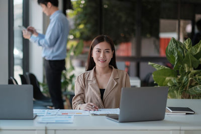 Businesswoman using laptop at table