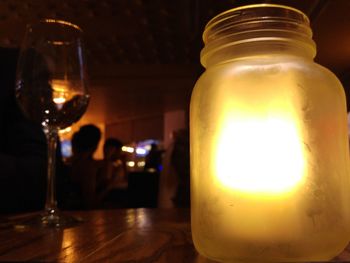 Close-up of lit candles on table