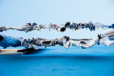 Directly below shot of laundry hanging on clothesline against clear sky