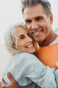 Close-up of smiling couple embracing at outdoors