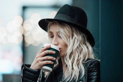 Portrait of young woman drinking coffee