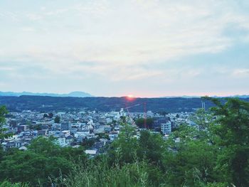 Cityscape against cloudy sky