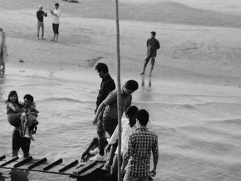 Men standing on beach