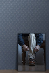 Low section of man sitting on chair