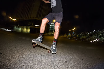 Blurred motion of man walking on road at night