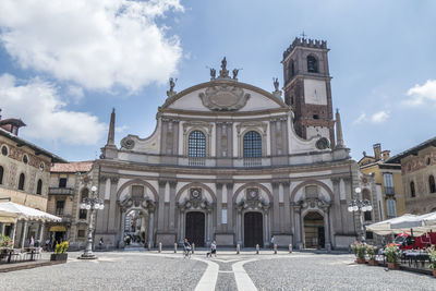 Facade of historic building against sky in city