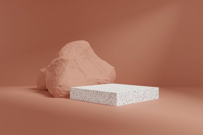 Close-up of stone stack on table against wall