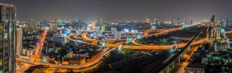High angle view of illuminated city street and buildings at night
