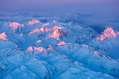 Aerial view of snowcapped mountains against sky