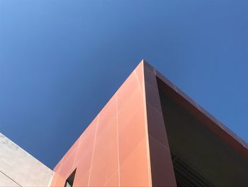 Low angle view of building against clear blue sky