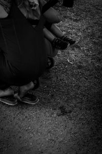 Low section of woman sitting on field