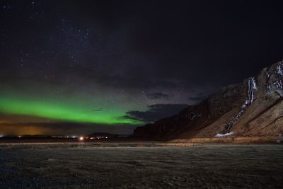 Scenic view of snowcapped mountains against sky at night