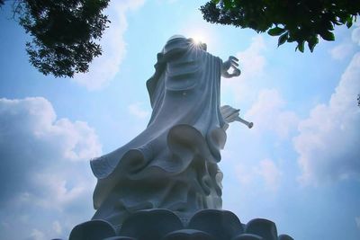 Low angle view of statue against cloudy sky