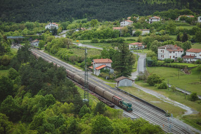 High angle view of train amidst buildings and trees