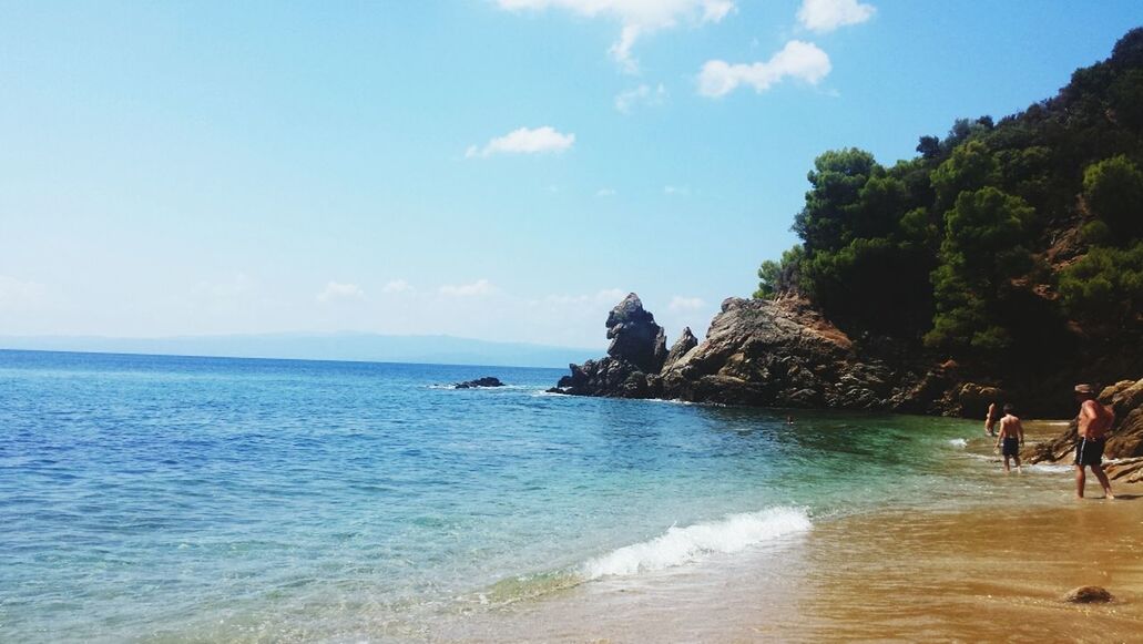 sea, water, beach, sky, scenics, horizon over water, tranquil scene, tranquility, beauty in nature, nature, rock formation, shore, cliff, coastline, rock - object, sand, idyllic, incidental people, vacations, day