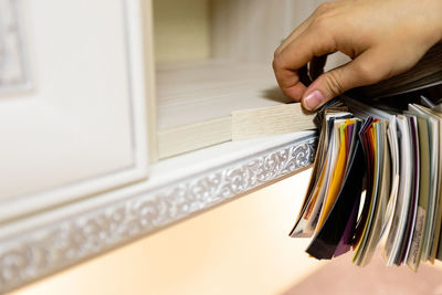 Cropped hand of woman holding book