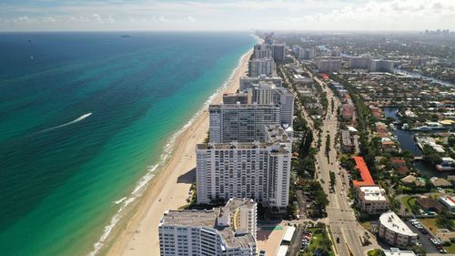 High angle view of sea and buildings against sky