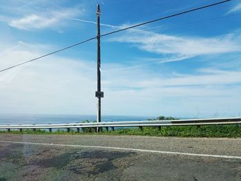 Road by sea against sky