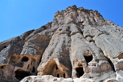 Low angle view of rock formation against sky