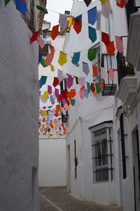 Multi colored flags hanging on wall of building