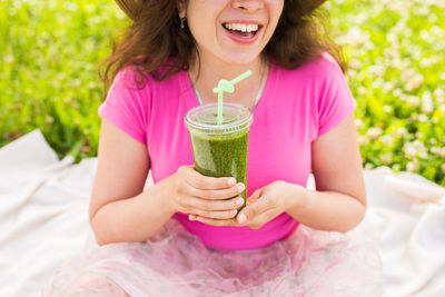 Midsection of a woman drinking drink