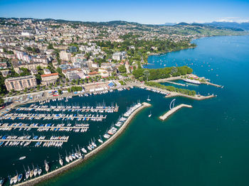 High angle view of city by sea against sky