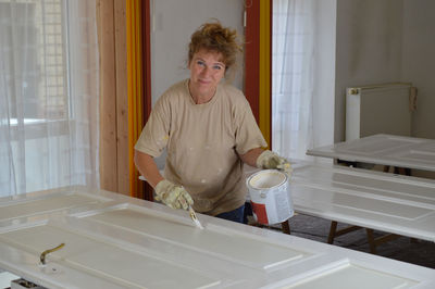 Portrait of a smiling young woman standing at home