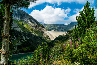 Scenic view of lake and mountains against sky