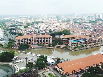 High angle view of buildings and river against sky