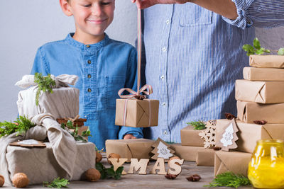 Full length of smiling young man holding box