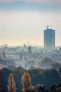 Buildings in city against sky during sunset