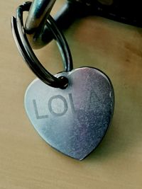 Close-up of padlocks on heart shape on table