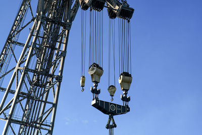 Low angle view of crane against sky