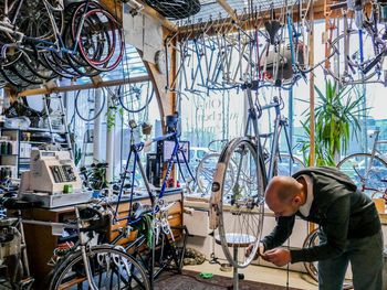 Man working with bicycle in store