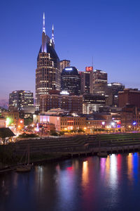 Illuminated buildings in city at waterfront