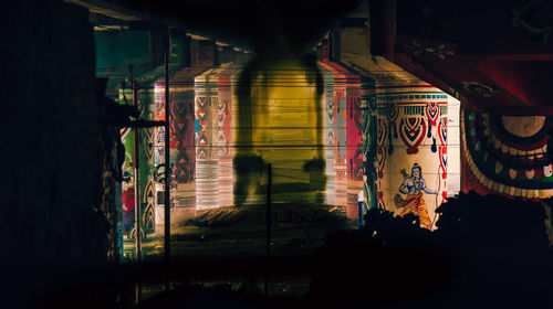 Illuminated lights seen through glass wall at night