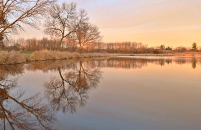 Scenic view of lake against sky during sunset