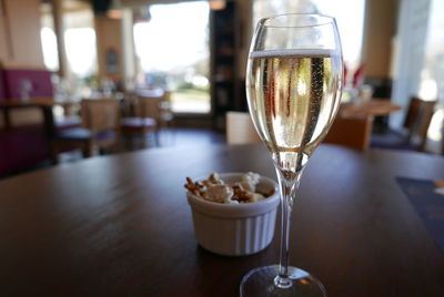 Close-up of champagne served in flute on table at restaurant